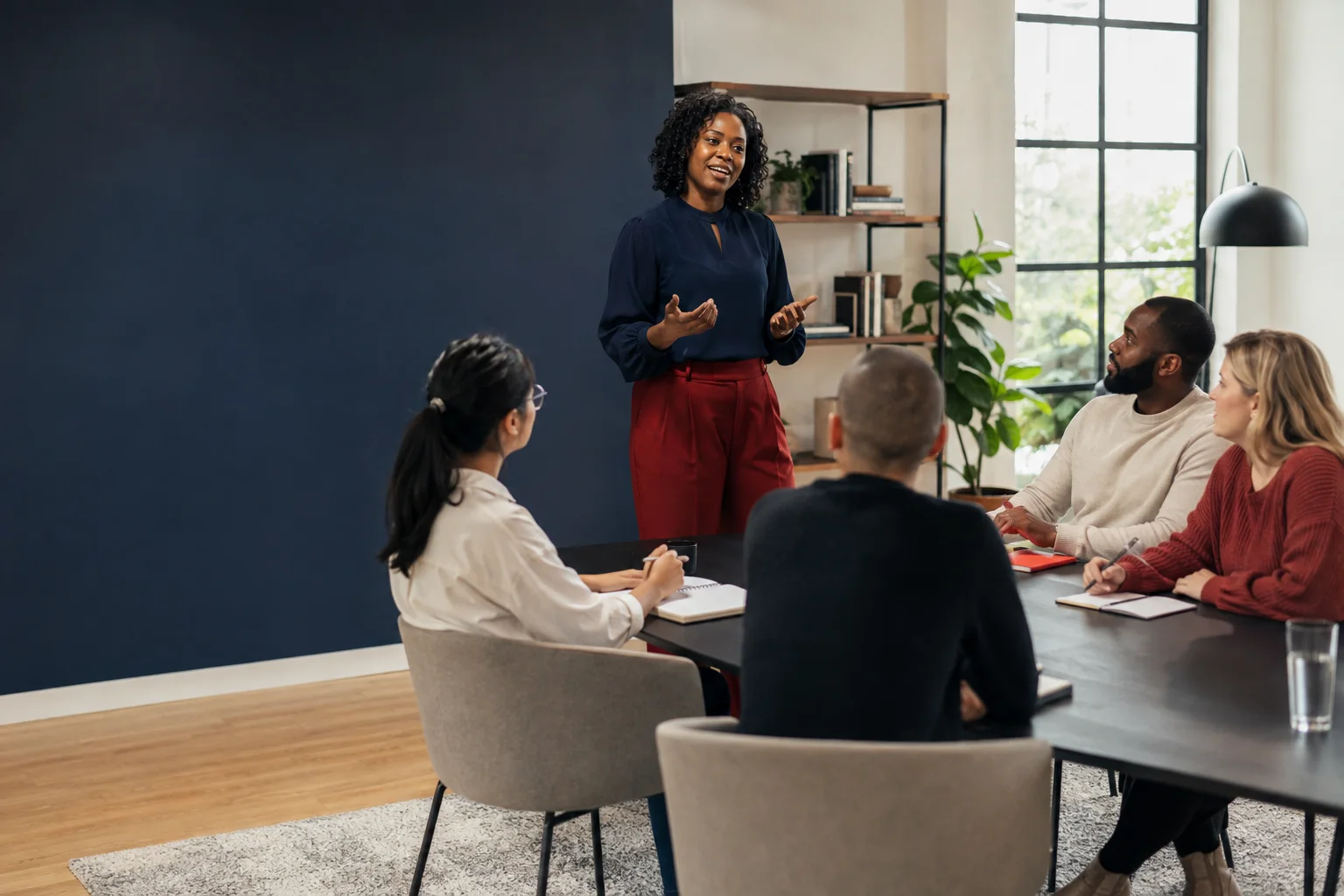 A facilitator leading a small workplace education session